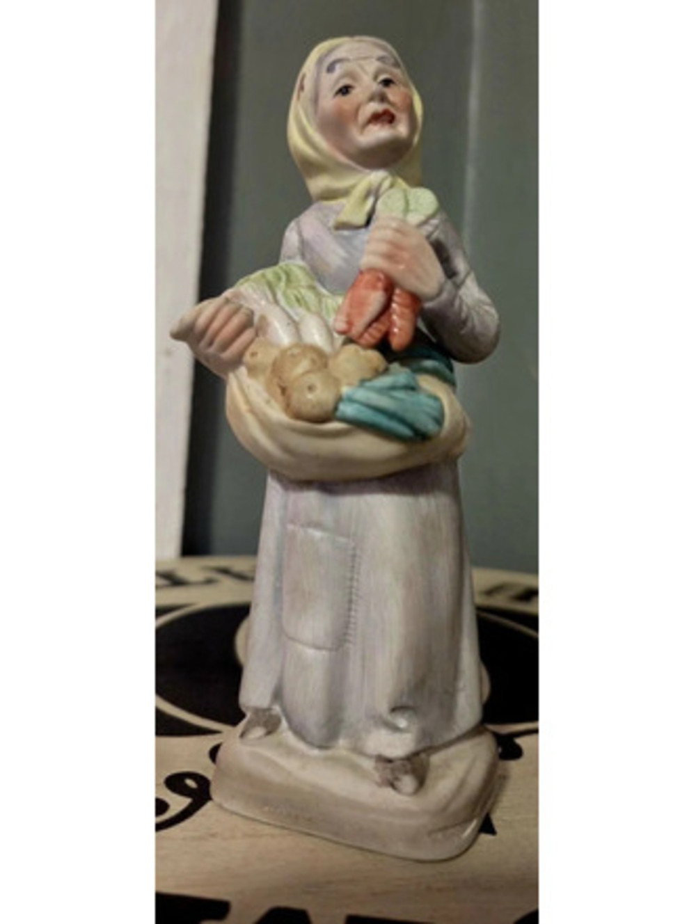 vintage porcelain figurine of an elderly female farmer  1970s and 1980s.